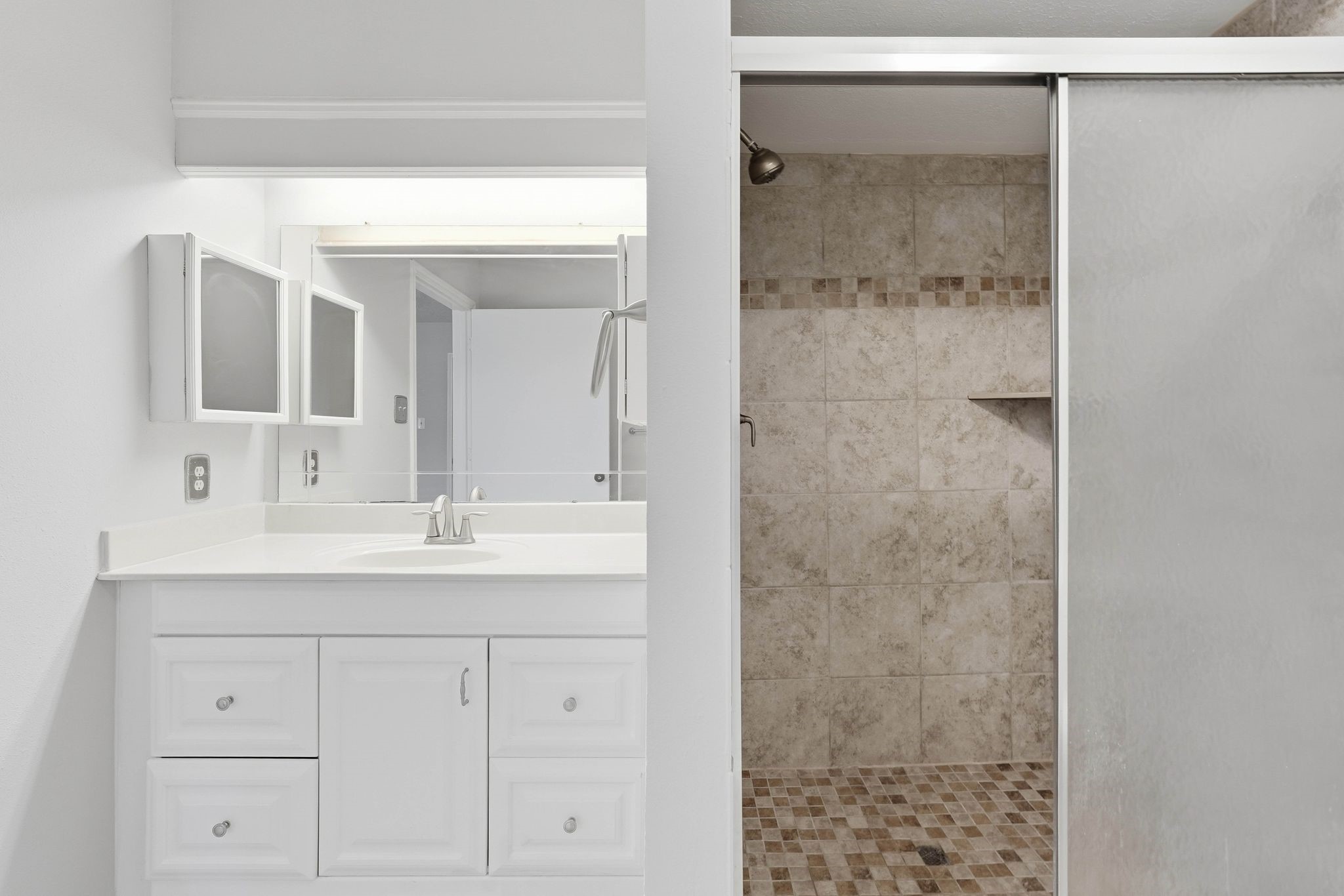 6807 Falling Waters Drive Spring, TX 77379 - Photo 14 of 22 a bathroom with a shower sink and mirror