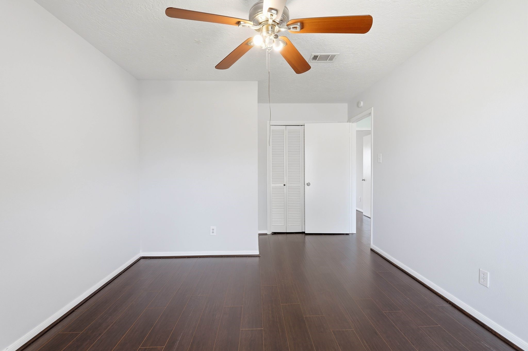 6807 Falling Waters Drive Spring, TX 77379 - Photo 17 of 22 a view of an empty room with wooden floor