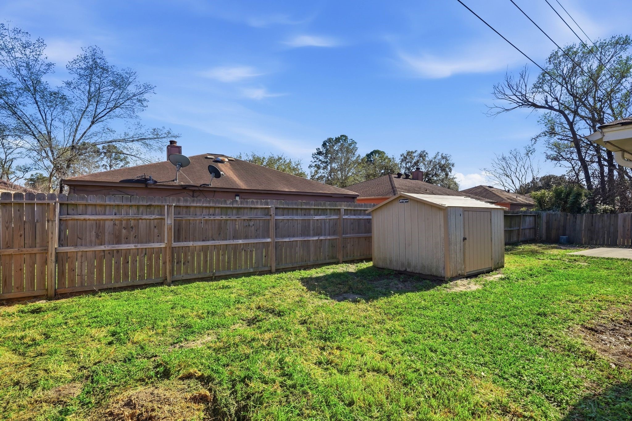 6807 Falling Waters Drive Spring, TX 77379 - Photo 21 of 22 a view of a backyard with potted plants and large tree