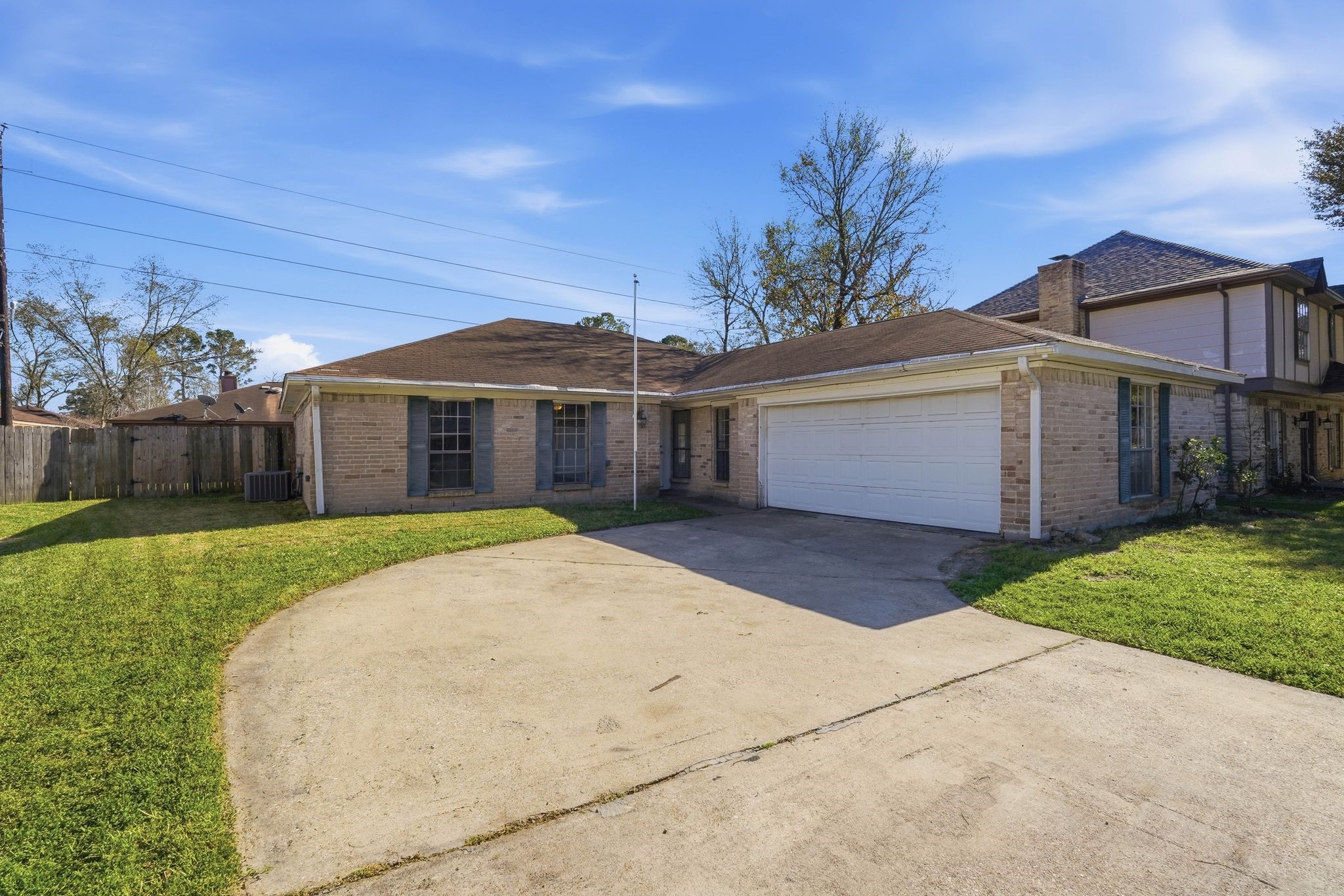 6807 Falling Waters Drive Spring, TX 77379 - Photo 3 of 22 a front view of a house with a garden and entryway
