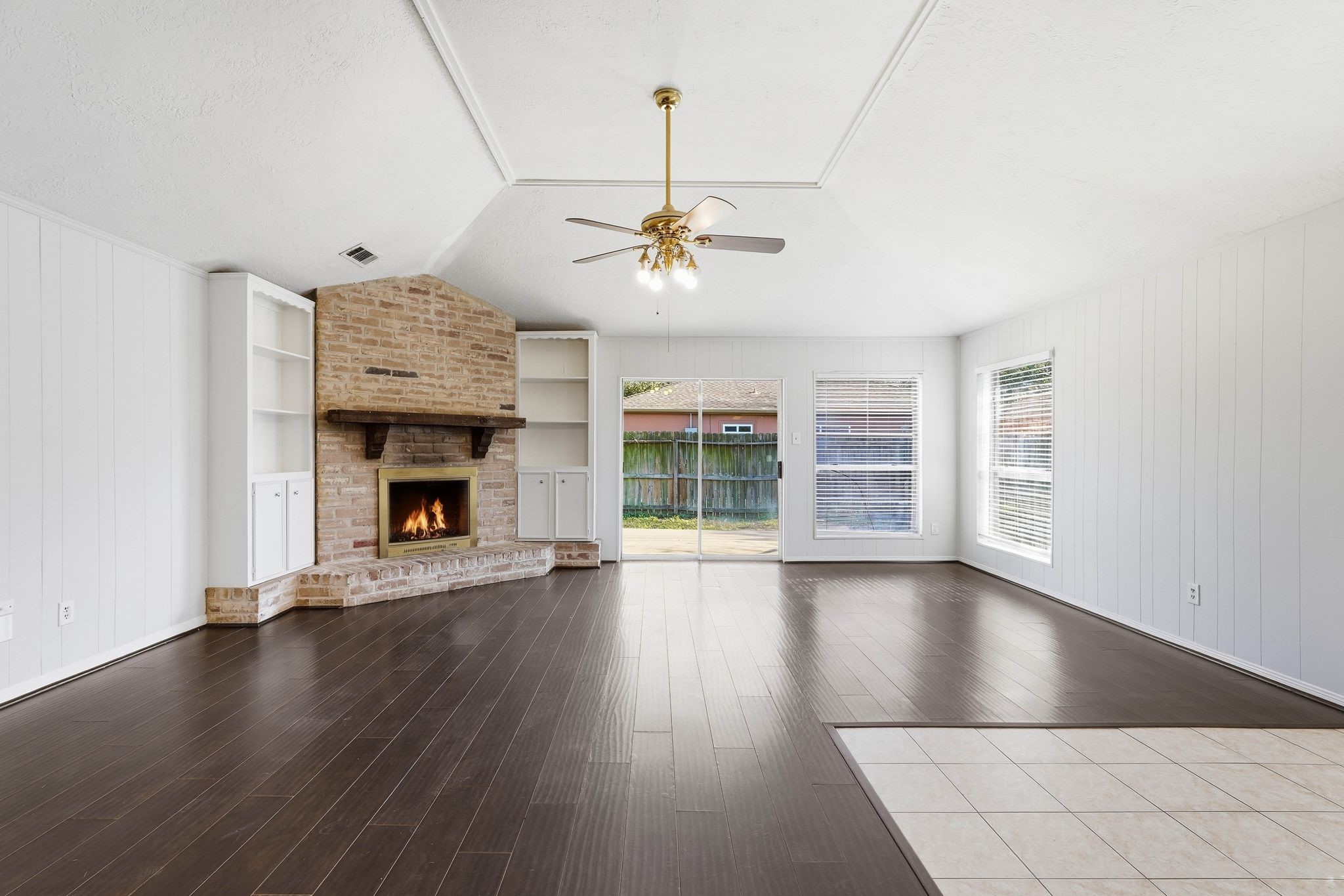 6807 Falling Waters Drive Spring, TX 77379 - Photo 6 of 22 a view of an empty room with wooden floor fireplace and a window
