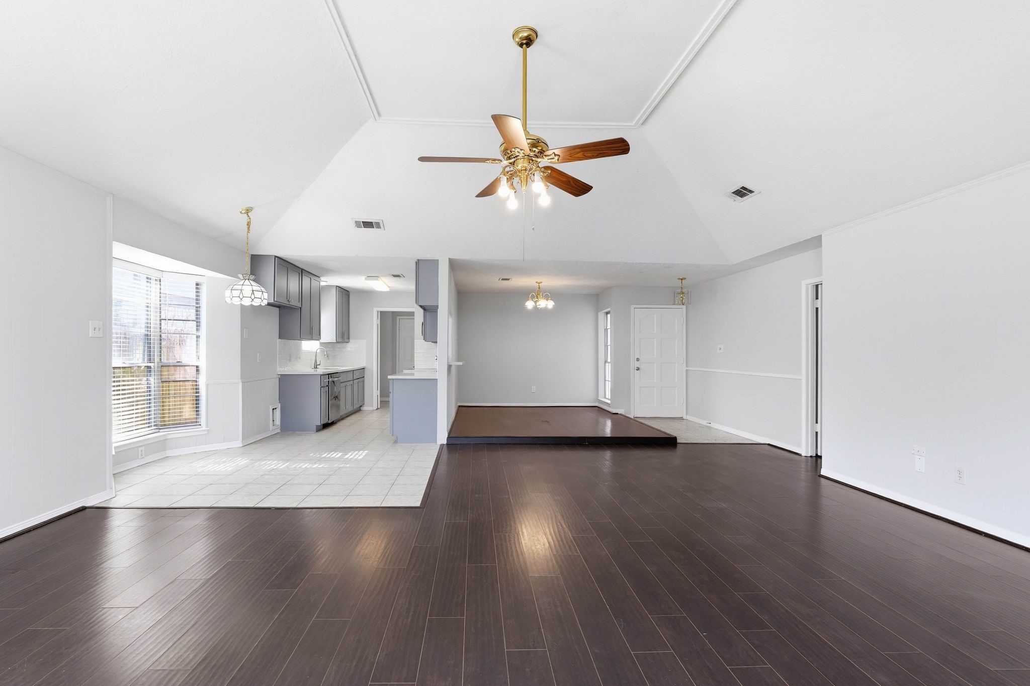 6807 Falling Waters Drive Spring, TX 77379 - Photo 7 of 22 a view of an empty room with wooden floor and a window