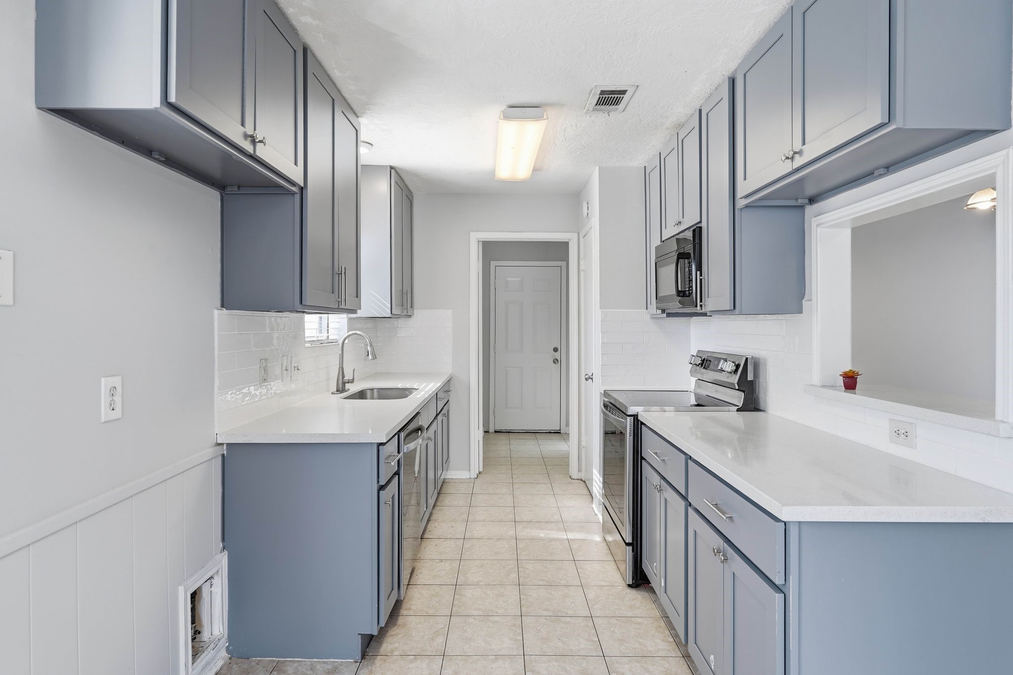 6807 Falling Waters Drive Spring, TX 77379 - Photo 10 of 22 a kitchen with a sink cabinets and appliances