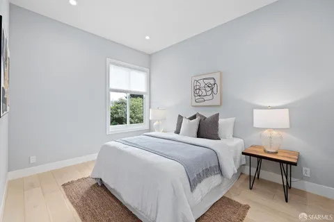 a bedroom with a bed and a lamp