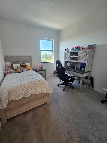 a bedroom with a workspace
