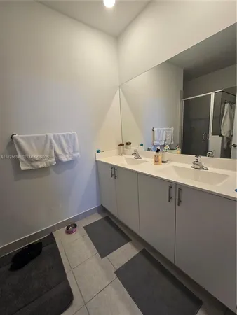 a room with a sink cabinets and wooden floor