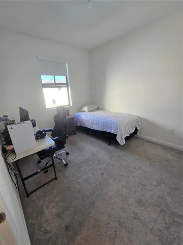 a bed room with a bed and a window