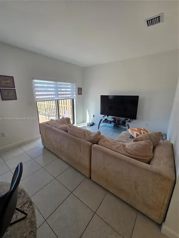 a living room with a couch and a flat screen tv