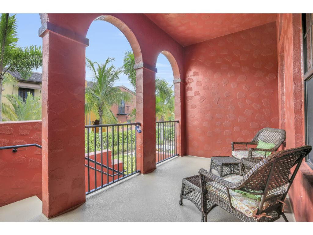 9041 Alturas Street, Unit 3803 Naples, FL 34113 - Photo 2 of 18 a balcony with outdoor seating and plants