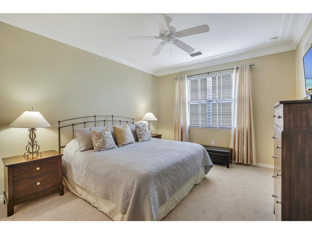 9041 Alturas Street, Unit 3803 Naples, FL 34113 - Photo 11 of 18 a bedroom with a bed and a night stand