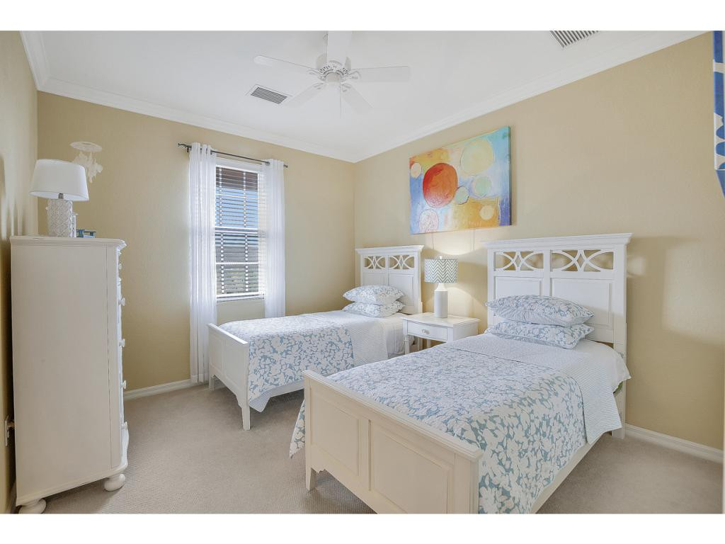 9041 Alturas Street, Unit 3803 Naples, FL 34113 - Photo 13 of 18 a bedroom with two beds and a window