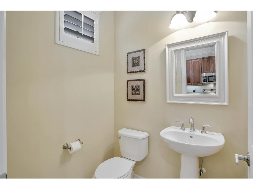 9041 Alturas Street, Unit 3803 Naples, FL 34113 - Photo 15 of 18 a bathroom with a toilet sink and mirror