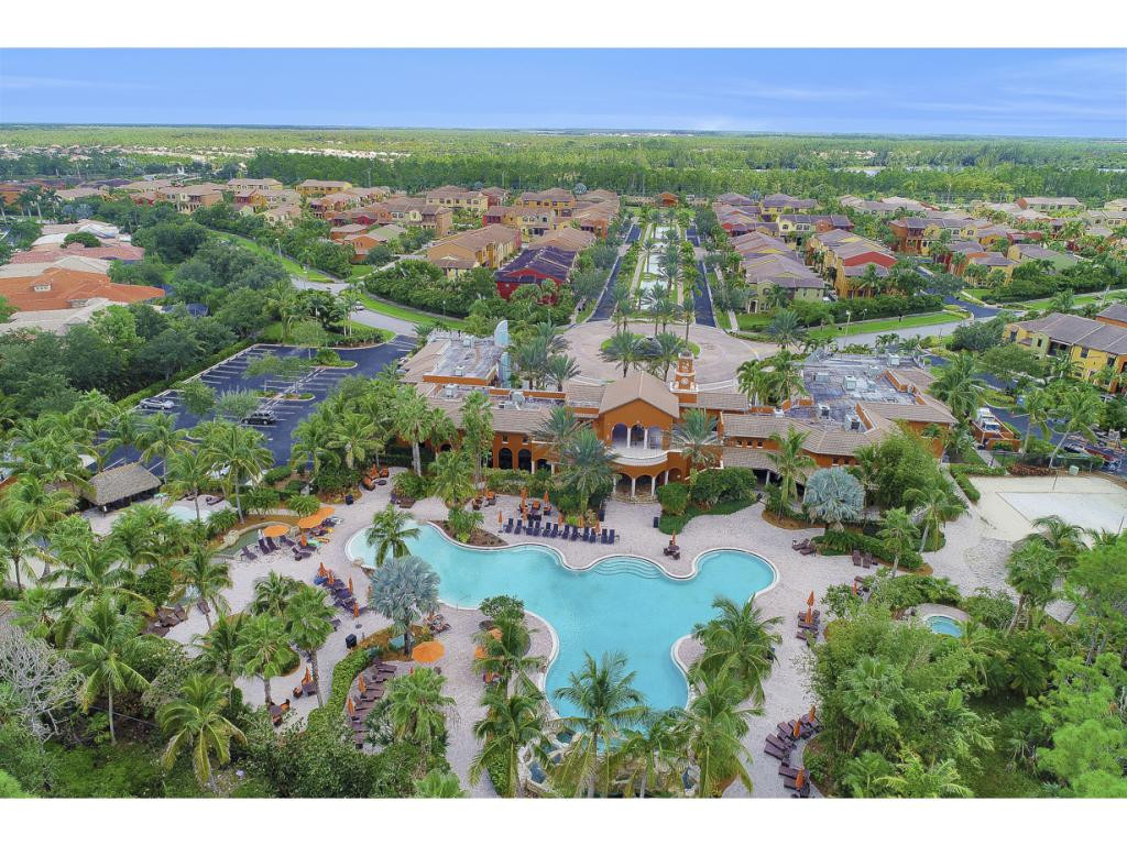 9041 Alturas Street, Unit 3803 Naples, FL 34113 - Photo 16 of 18 an aerial view of a city with lots of residential buildings ocean and mountain view in back