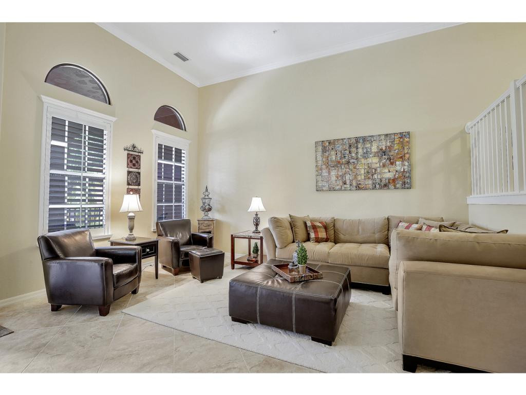 9041 Alturas Street, Unit 3803 Naples, FL 34113 - Photo 7 of 18 a living room with furniture and large windows
