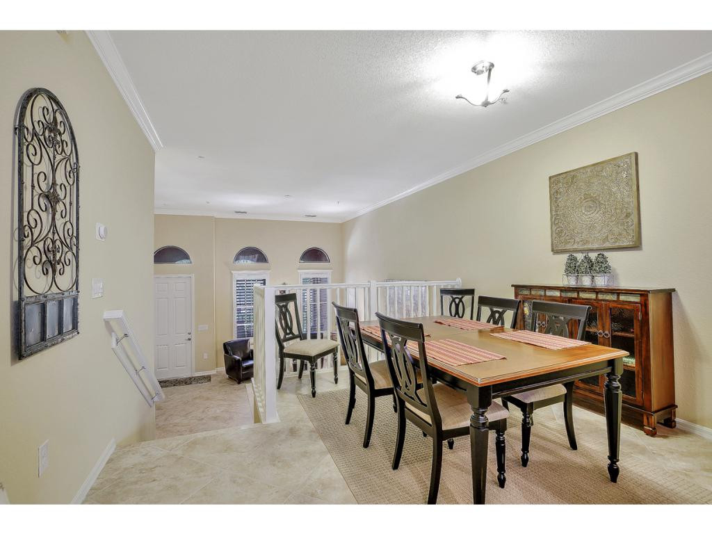 9041 Alturas Street, Unit 3803 Naples, FL 34113 - Photo 8 of 18 a view of a dining room with furniture