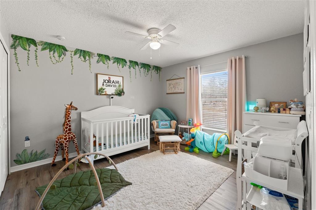 15335 Fleetwood Road Weeki Wachee, FL 34614 - Photo 26 of 40 a bedroom with a bed and a chandelier
