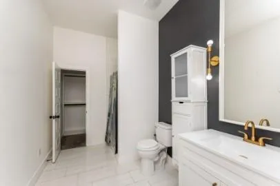 a bathroom with a granite countertop sink toilet and shower