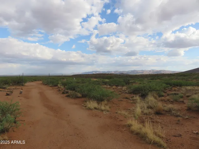 a view of a lake with beach and city
