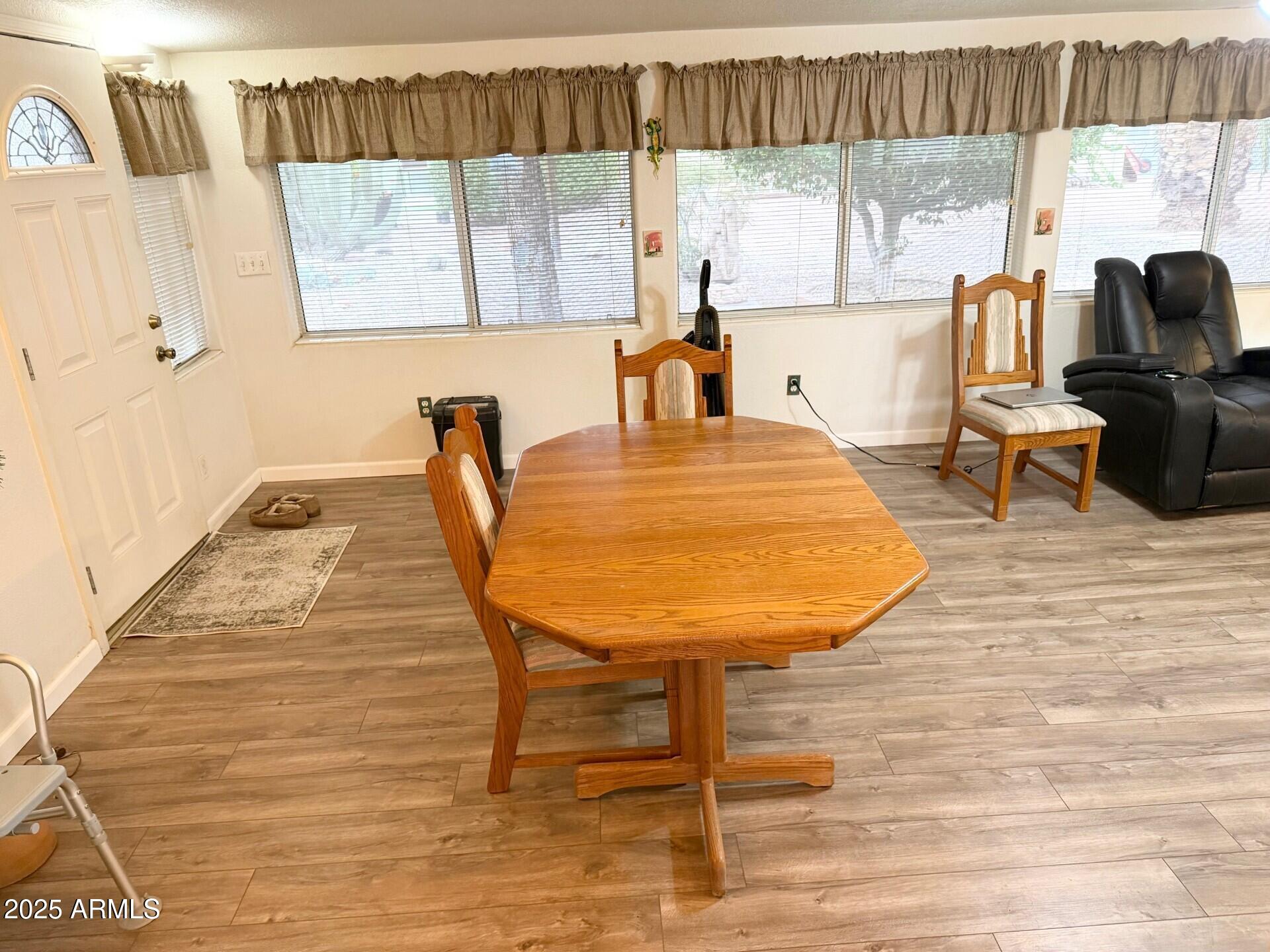 823 South 79th Way Mesa, AZ 85208 - Photo 11 of 46 a living room with a table chairs and a large window