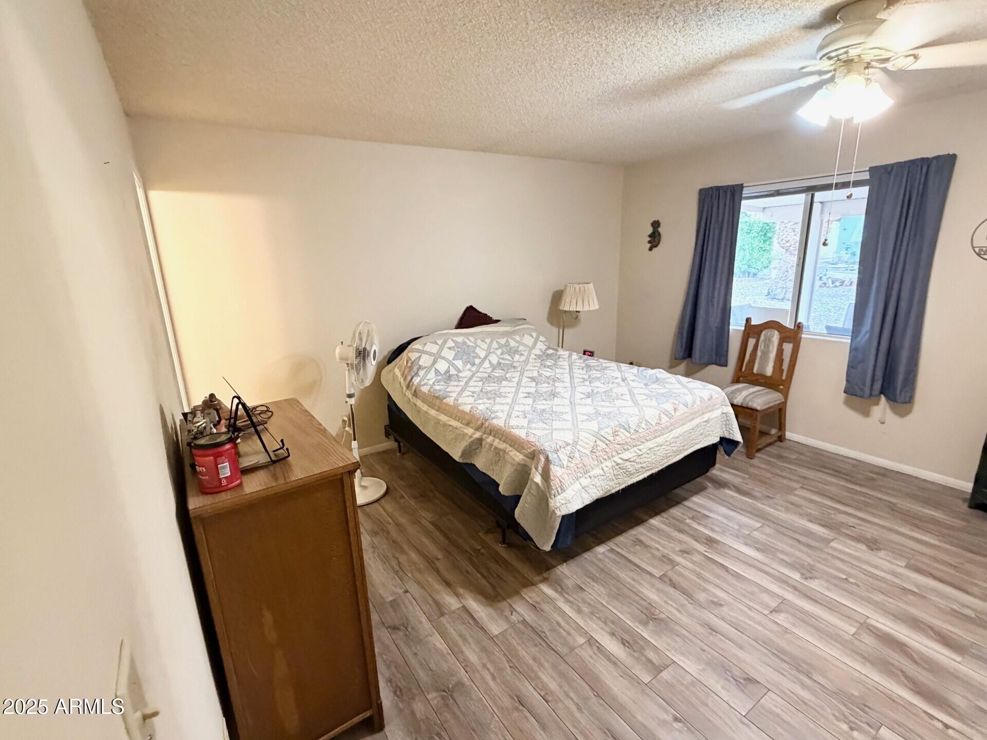 823 South 79th Way Mesa, AZ 85208 - Photo 15 of 46 a bedroom with a bed and wooden floor