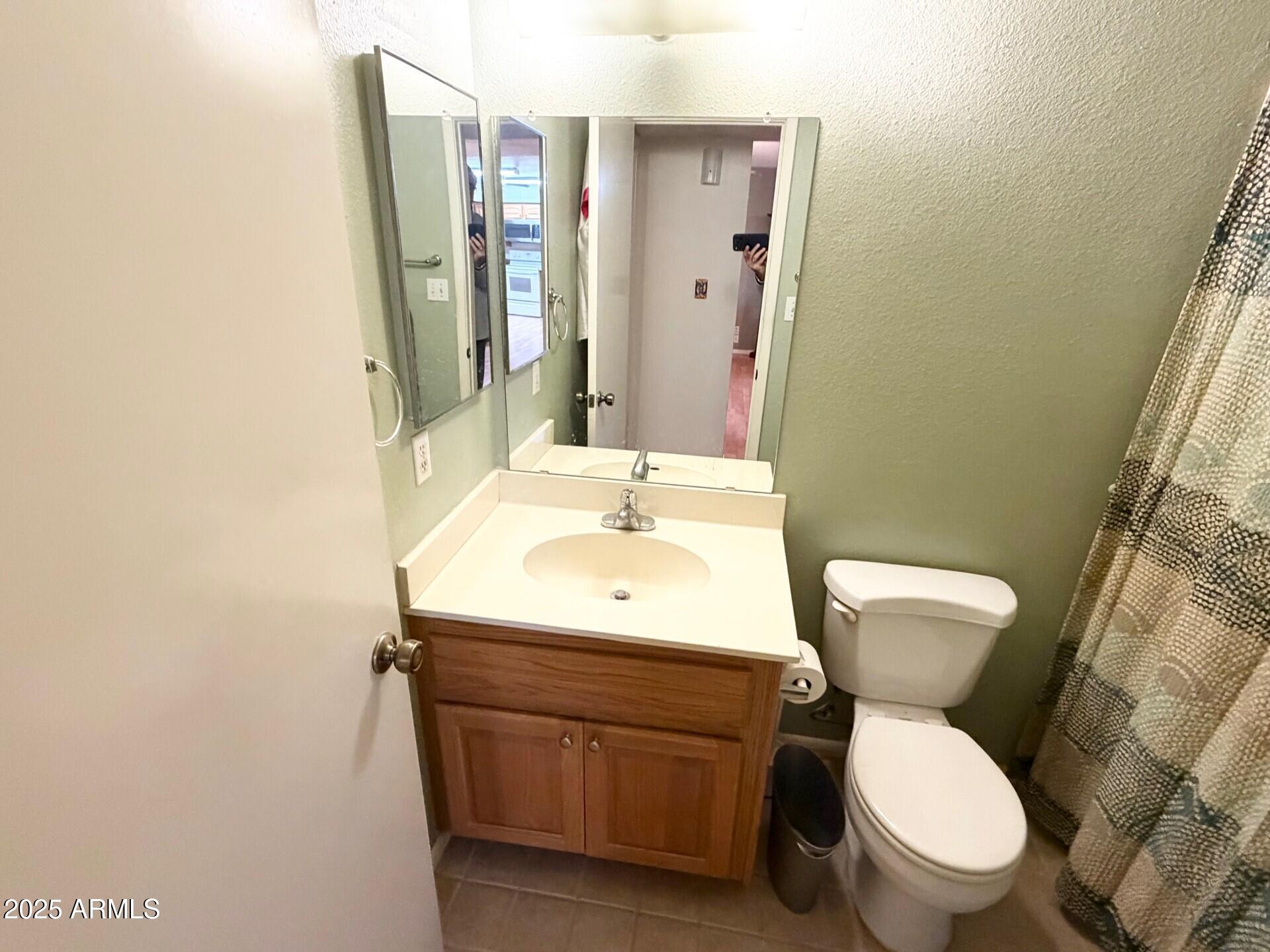 823 South 79th Way Mesa, AZ 85208 - Photo 20 of 46 a bathroom with a toilet sink and mirror