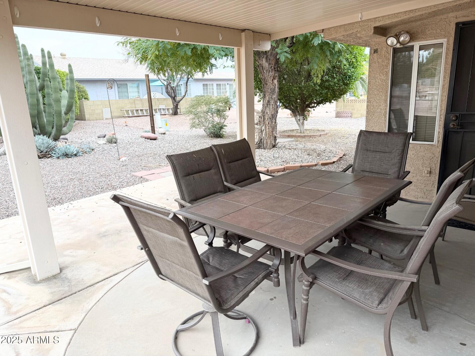 823 South 79th Way Mesa, AZ 85208 - Photo 24 of 46 a view of a patio with a table chairs and backyard
