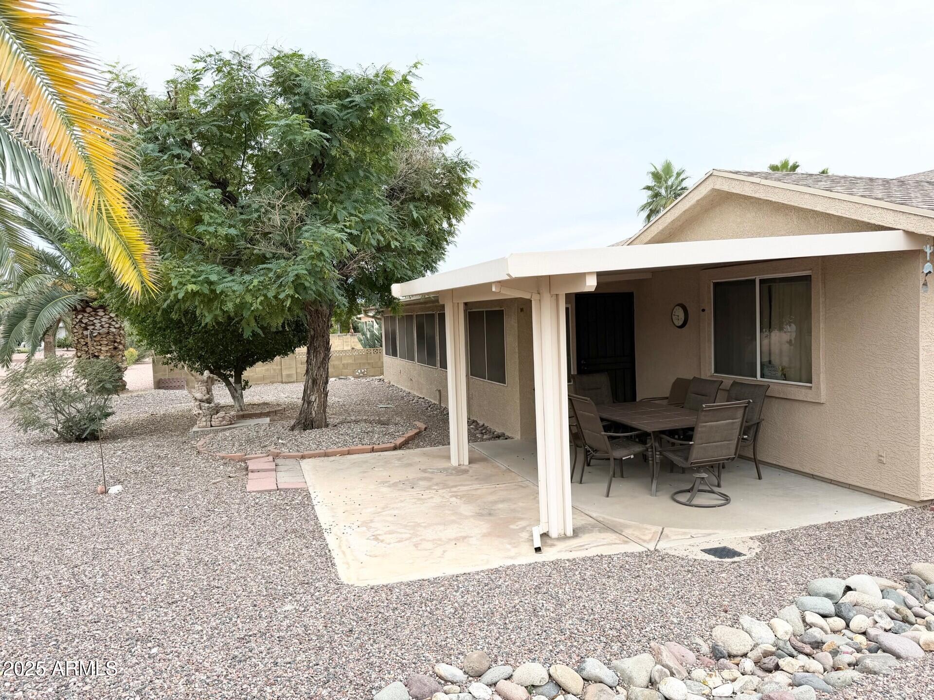 823 South 79th Way Mesa, AZ 85208 - Photo 25 of 46 a view of a patio with table and chairs and potted plants