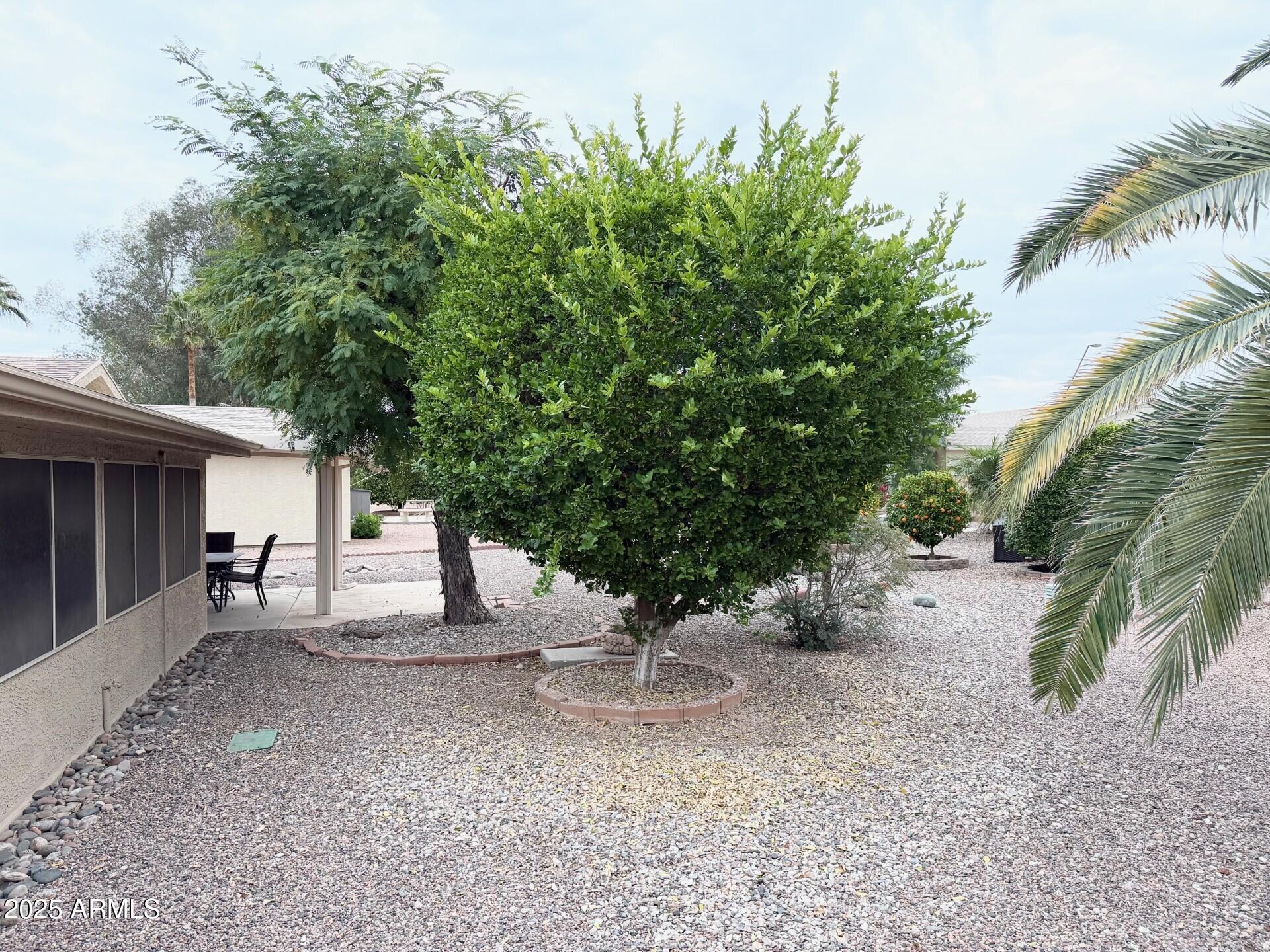823 South 79th Way Mesa, AZ 85208 - Photo 27 of 46 a view of a house with a yard and sitting area