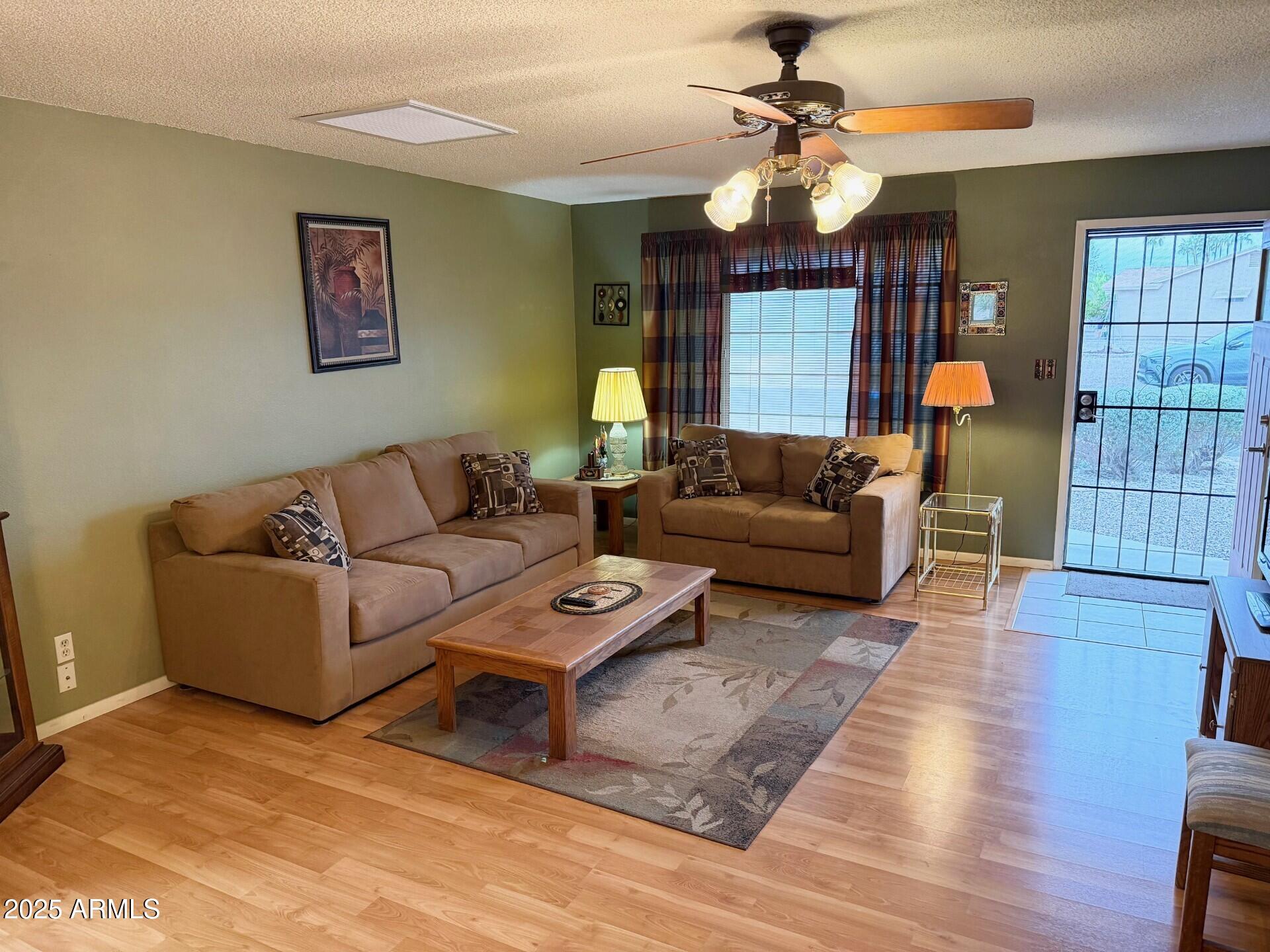 823 South 79th Way Mesa, AZ 85208 - Photo 4 of 46 a living room with furniture a chandelier and a rug