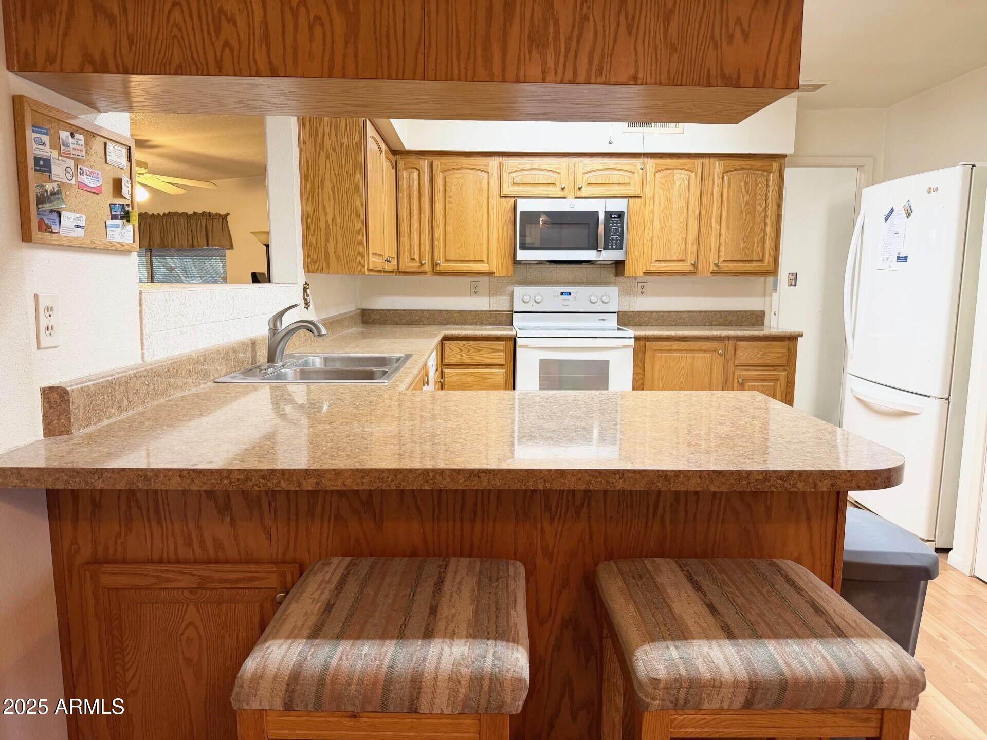 823 South 79th Way Mesa, AZ 85208 - Photo 7 of 46 a kitchen with stainless steel appliances a sink a table and chairs