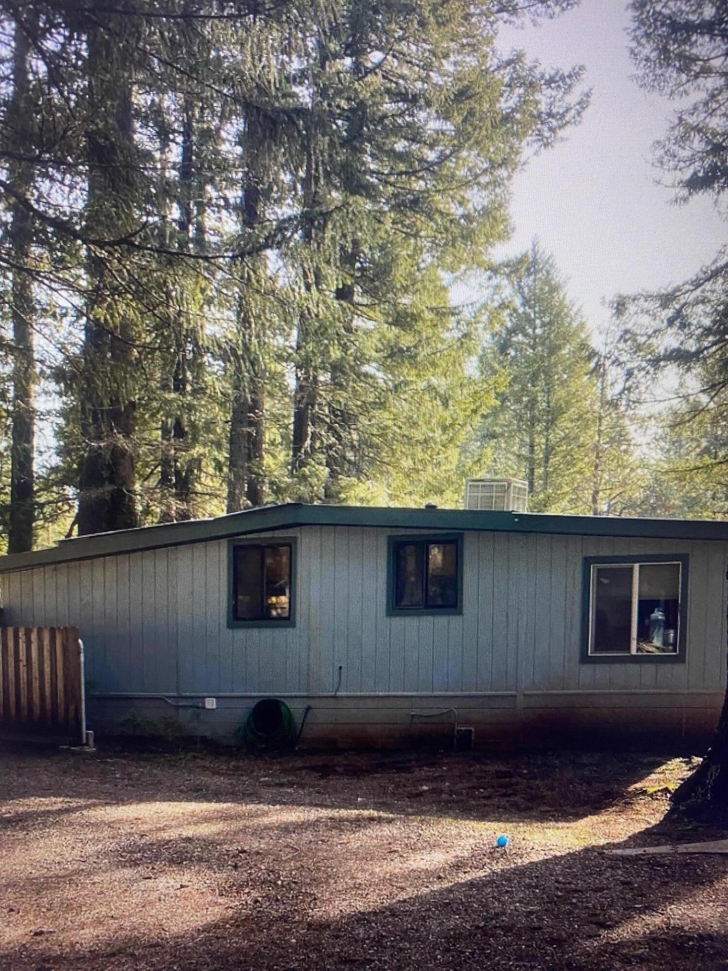 780 Lone Mountain Road O'Brien, OR 97534 - Photo 18 of 33 a house with trees in the background
