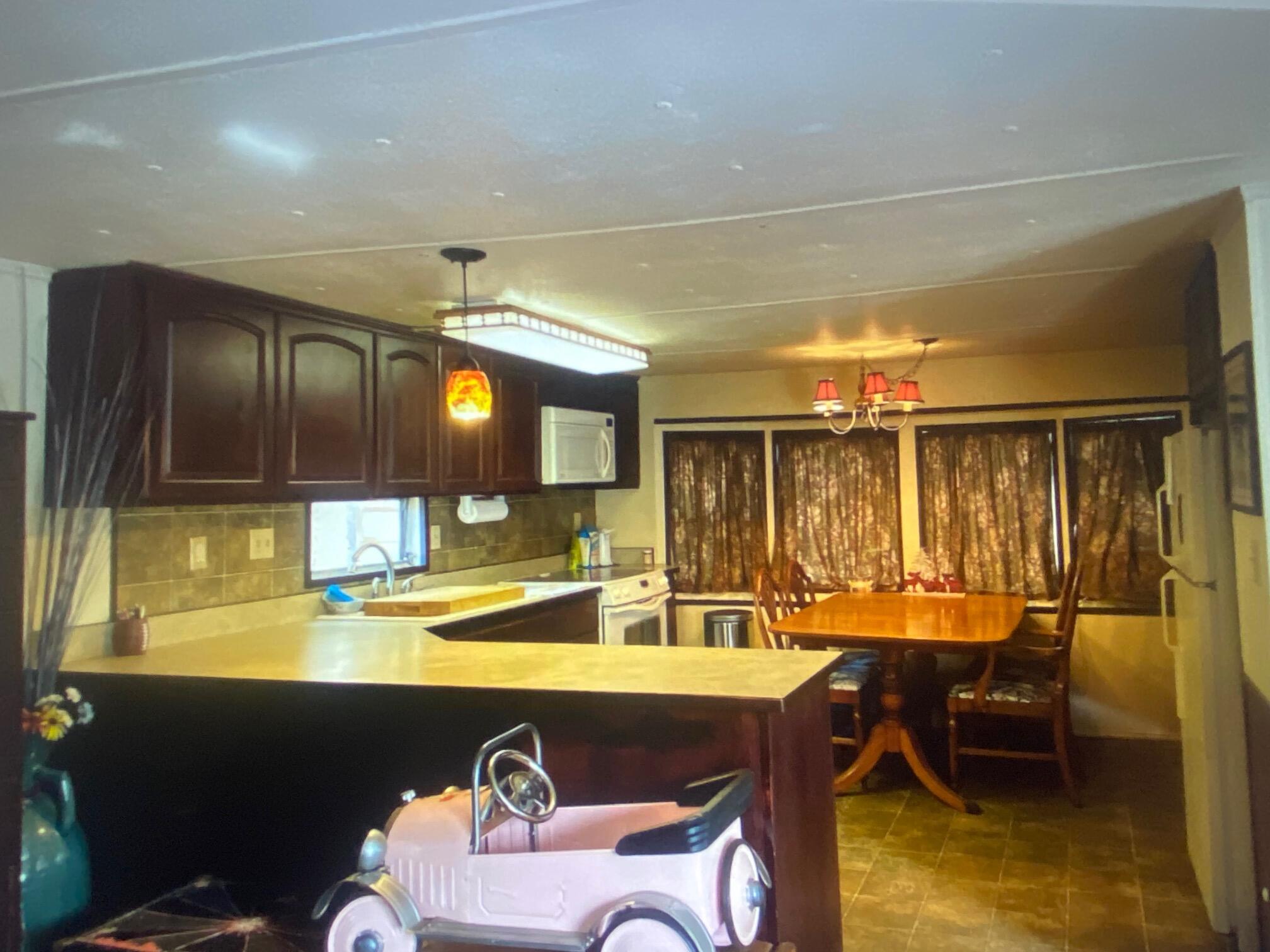 780 Lone Mountain Road O'Brien, OR 97534 - Photo 22 of 33 a view of a dining room with furniture and window