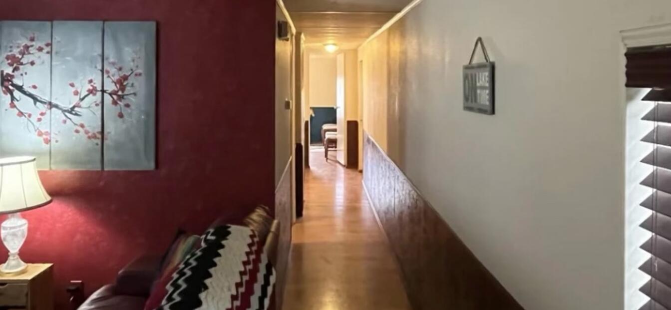 780 Lone Mountain Road O'Brien, OR 97534 - Photo 23 of 33 a view of a hallway with wooden floor and staircase