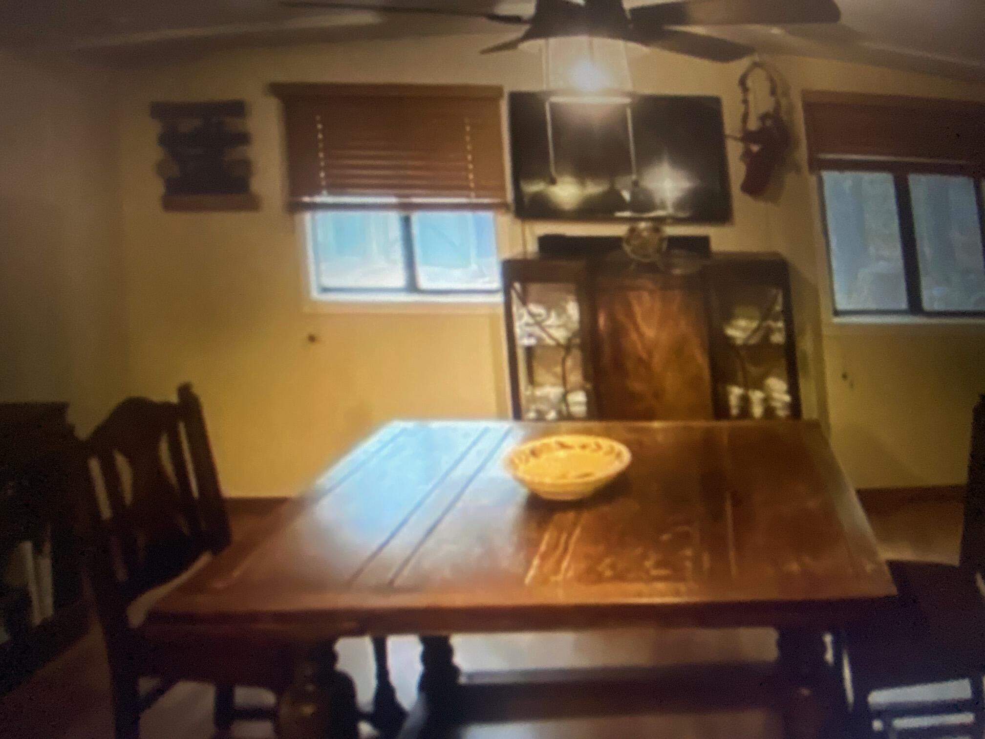 780 Lone Mountain Road O'Brien, OR 97534 - Photo 9 of 33 a kitchen with a table chairs and a wooden floor