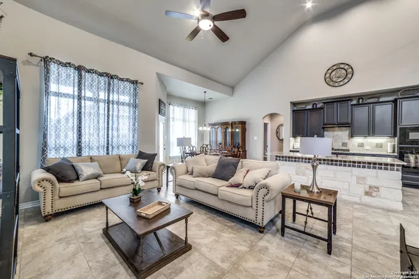 a living room with furniture and kitchen view