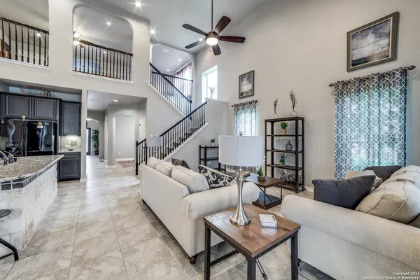 a living room with furniture and a chandelier