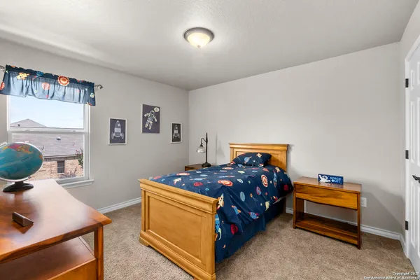 a bedroom with a bed and a table in it