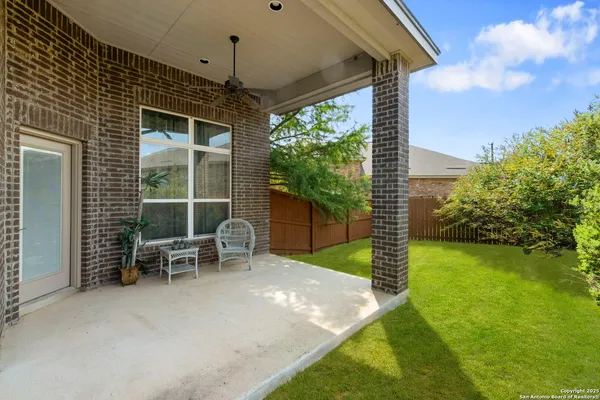 a view of a chairs with a table in the patio