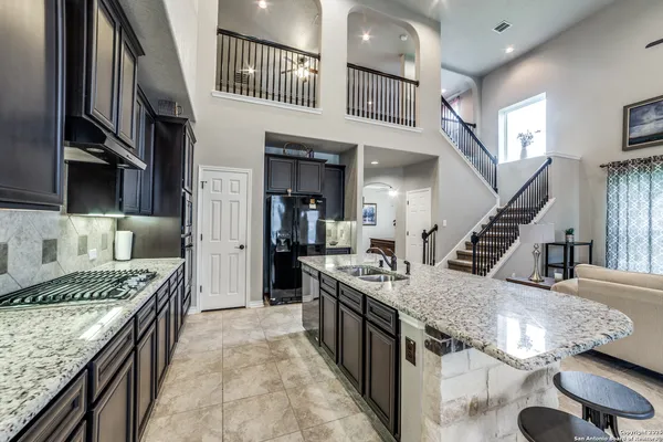 a kitchen with stove and refrigerator