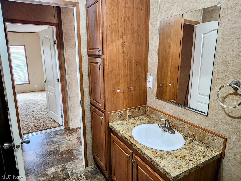 2925 Barth Road Belpre, OH 45714 - Photo 15 of 19 Bathroom featuring vanity with extensive cabinet space and tile flooring