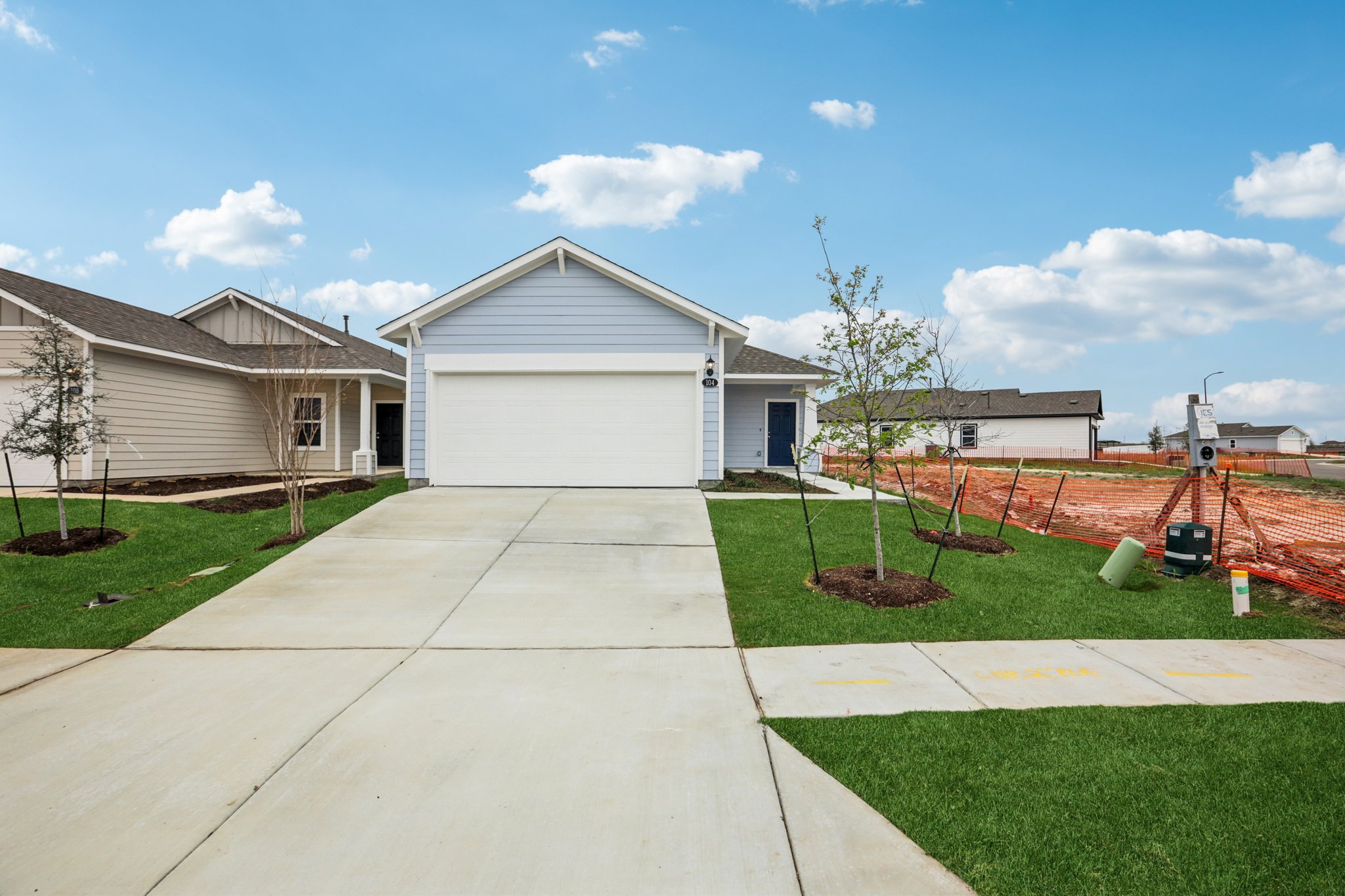 104 Summer Drive Elgin, TX 78621 - Photo 1 of 40 a front view of a house with garden