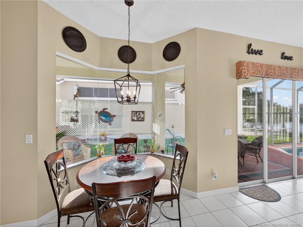 618 Southwest Lake Charles Circle Port St. Lucie, FL 34986 - Photo 11 of 29 a view of a dining room with furniture and chandelier