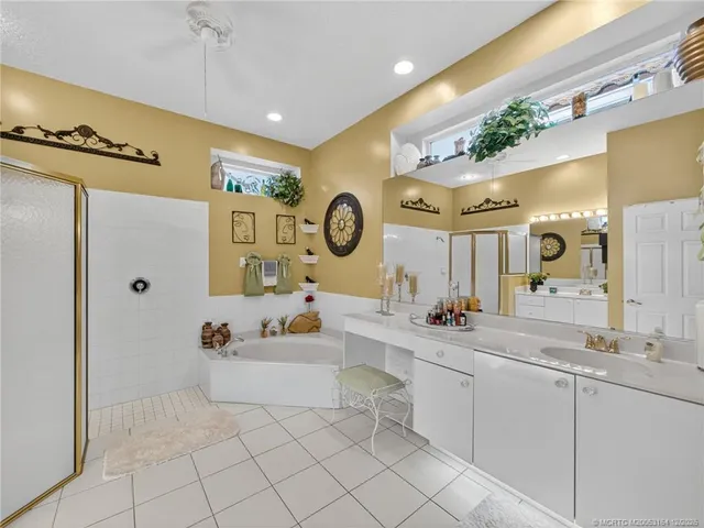 a spacious bathroom with a sink mirror and bathtub