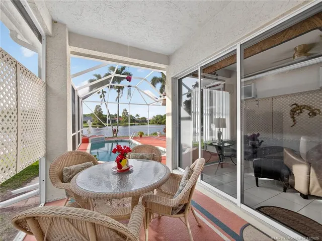 a dining room with furniture a chandelier and wooden floor