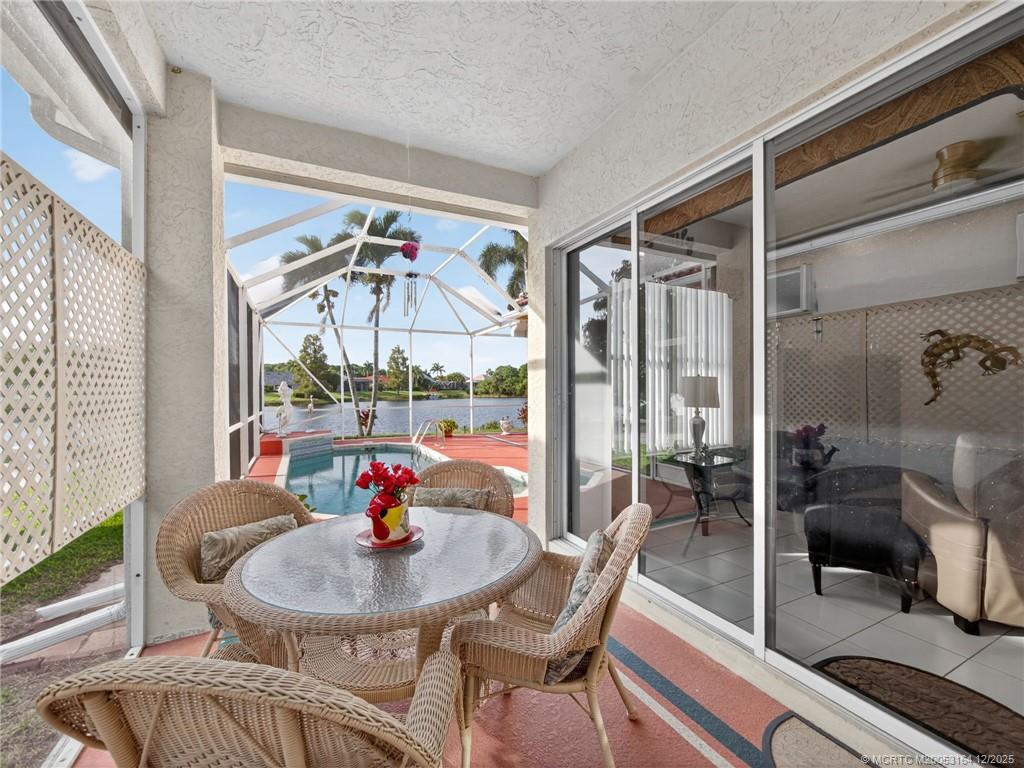 618 Southwest Lake Charles Circle Port St. Lucie, FL 34986 - Photo 24 of 29 a dining room with furniture a chandelier and wooden floor