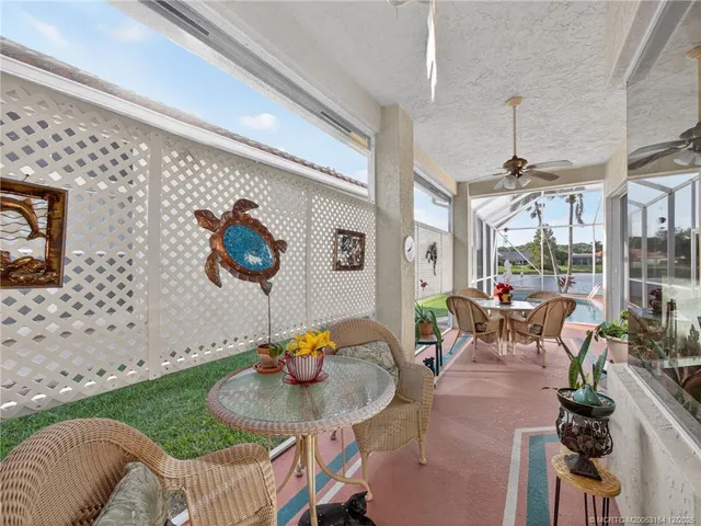 a view of a dining room with furniture one side kitchen view and wooden floor