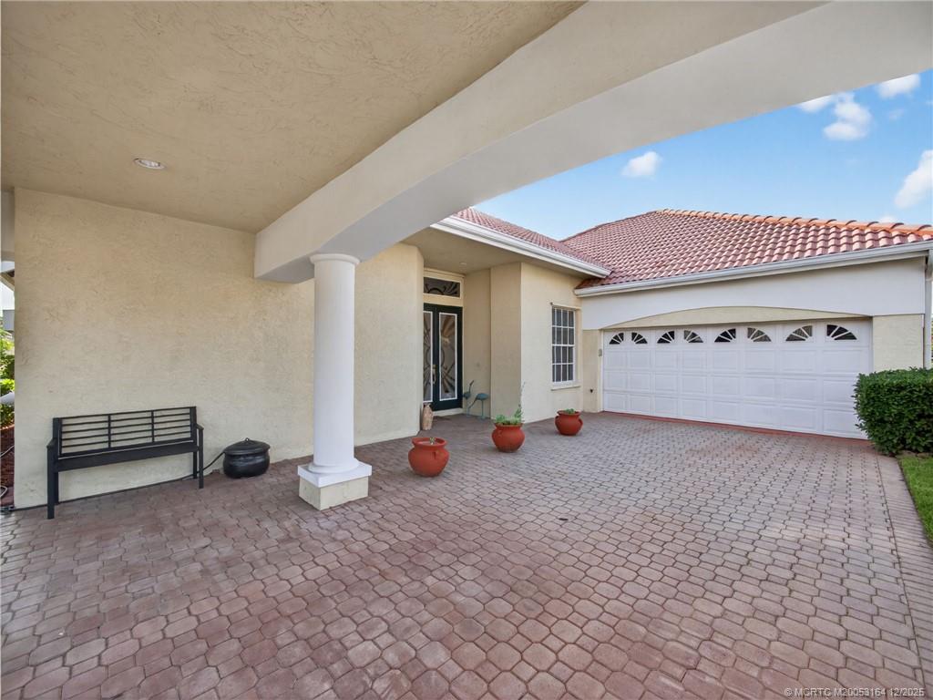 618 Southwest Lake Charles Circle Port St. Lucie, FL 34986 - Photo 29 of 29 a view of a room with gym equipment and a large window