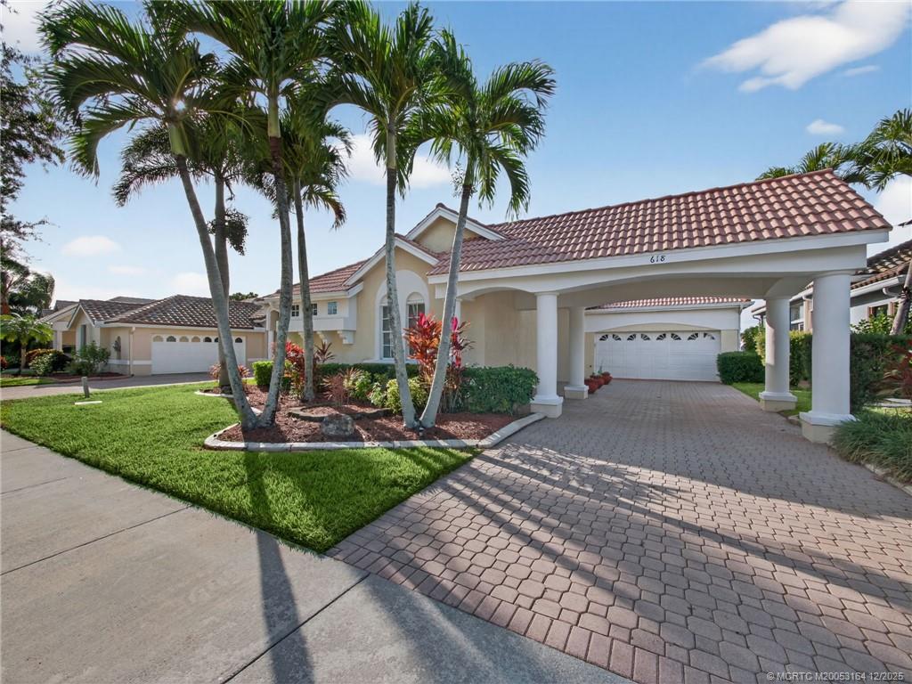 618 Southwest Lake Charles Circle Port St. Lucie, FL 34986 - Photo 3 of 29 a front view of a house with garden and parking