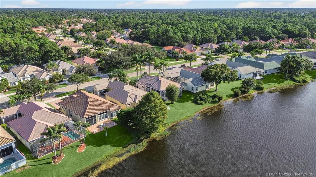 618 Southwest Lake Charles Circle Port St. Lucie, FL 34986 - Photo 6 of 29 an aerial view of a house with a garden and lake view