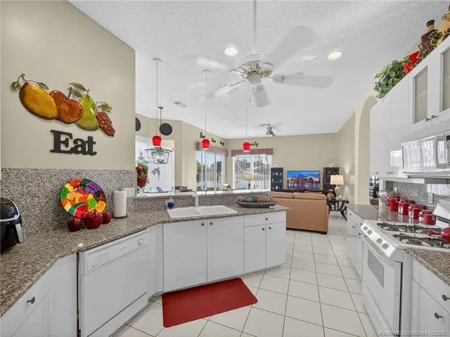 a view of kitchen with counter top space cabinets and appliances